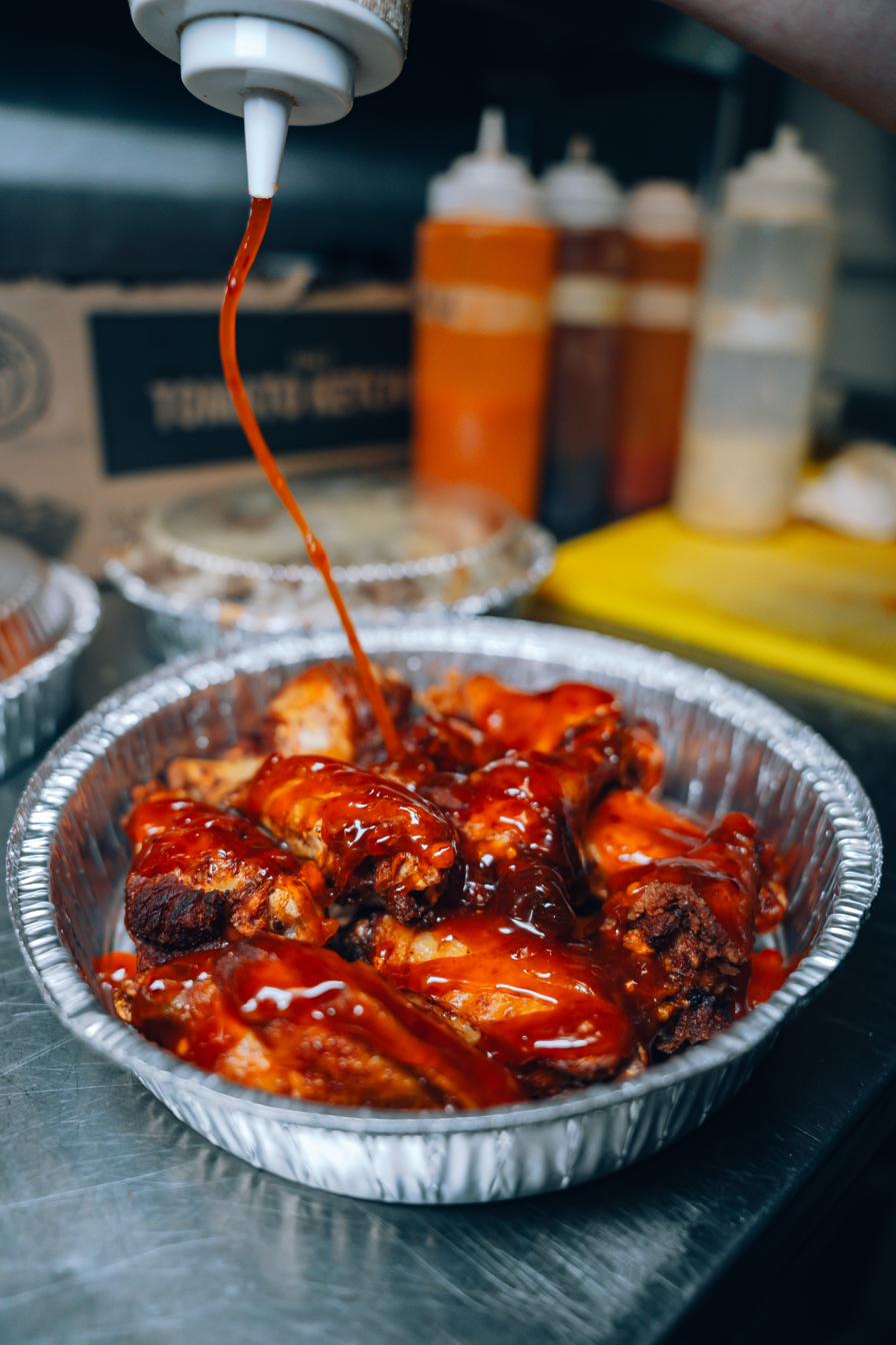Wings being sauced
